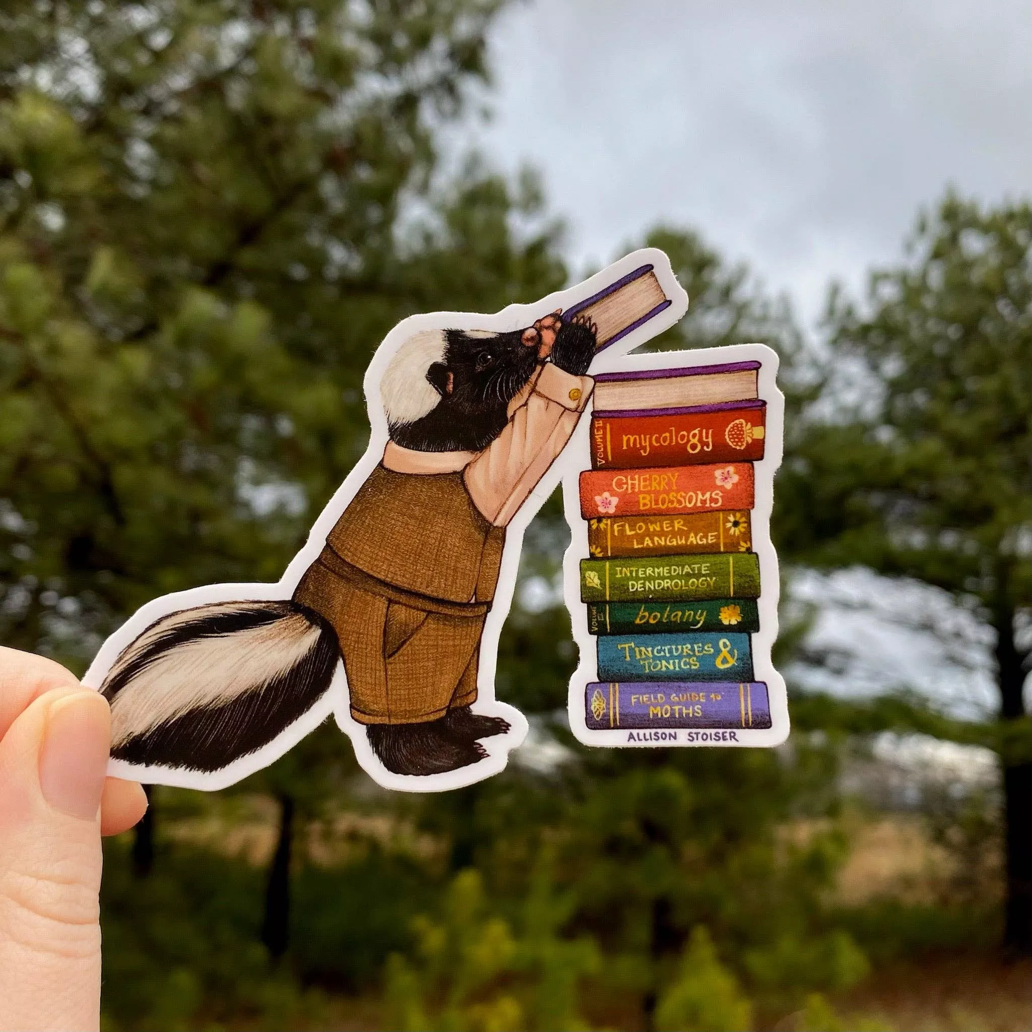Bookish Skunk With Rainbow Book Stack Vinyl Sticker